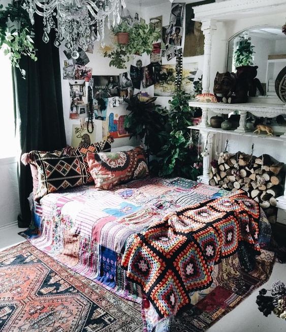 bold boho chic textiles and rugs, some artworks and greenery for a boho yet glam look
