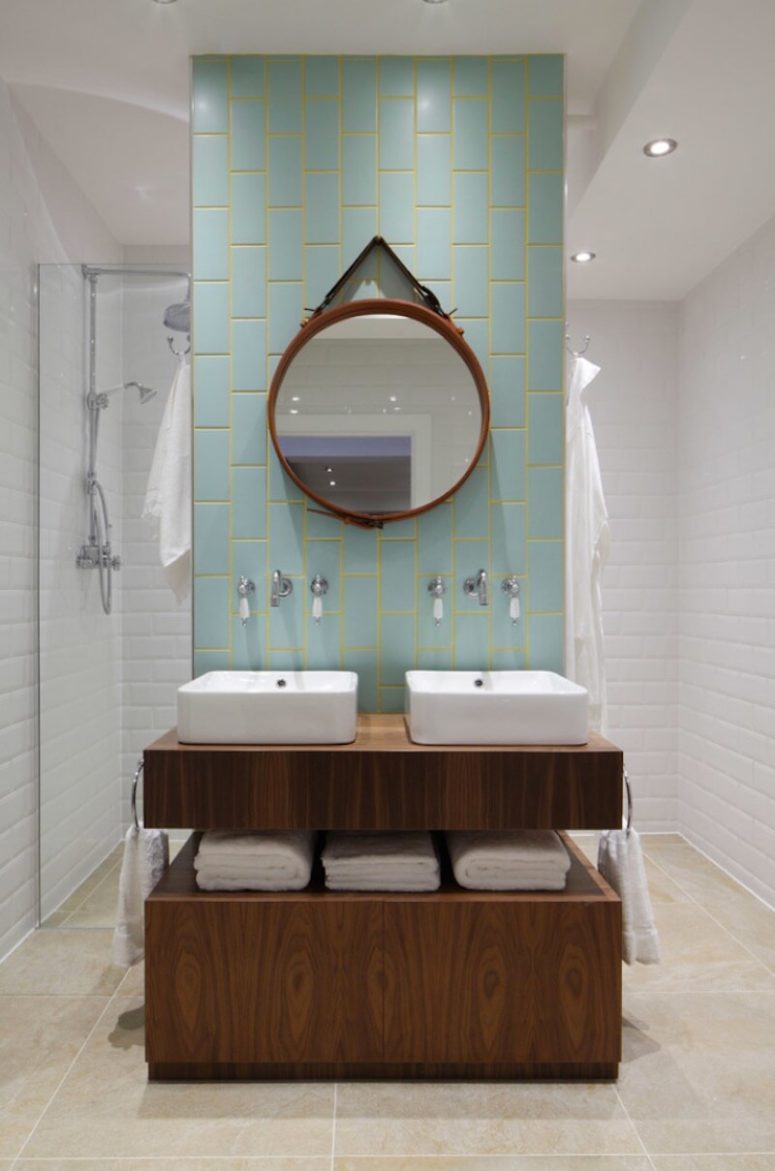 a vanity highlighted with blue tiles and neon yellow grout in between adds a colorful touch