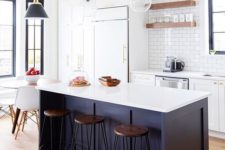 18 a white kitchen and a midnight blue kitchen island with a white countertop for a chic and catchy look