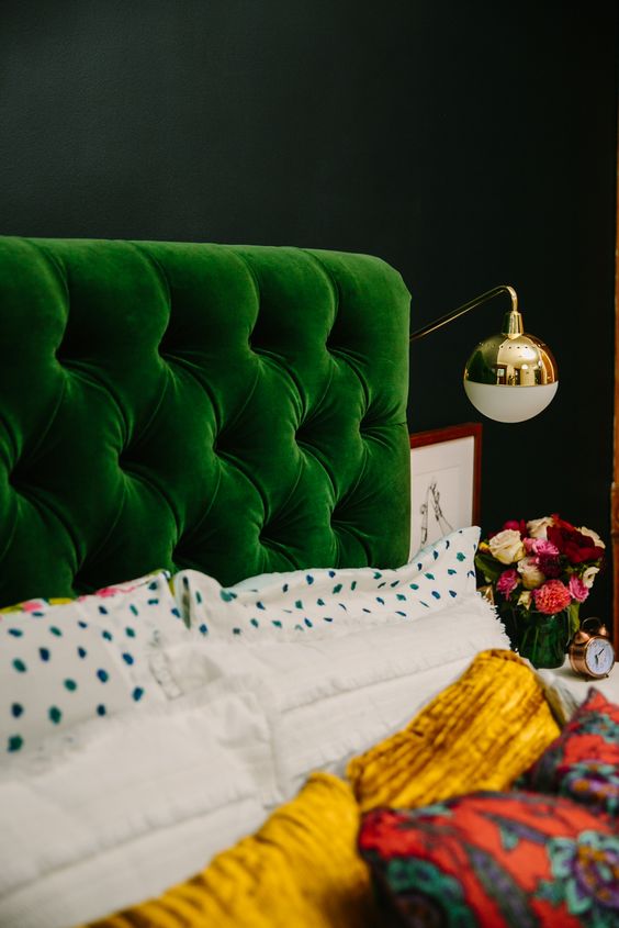 an emerald diamond upholstery headboard is great to add color to a moody space