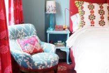 19 a red carpet, a red upholstered bed and red printed curtains contrast the blue bedrooms and furniture