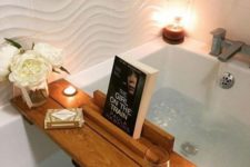 19 a stylish bath caddy with a glass holder and a book or gadget holder