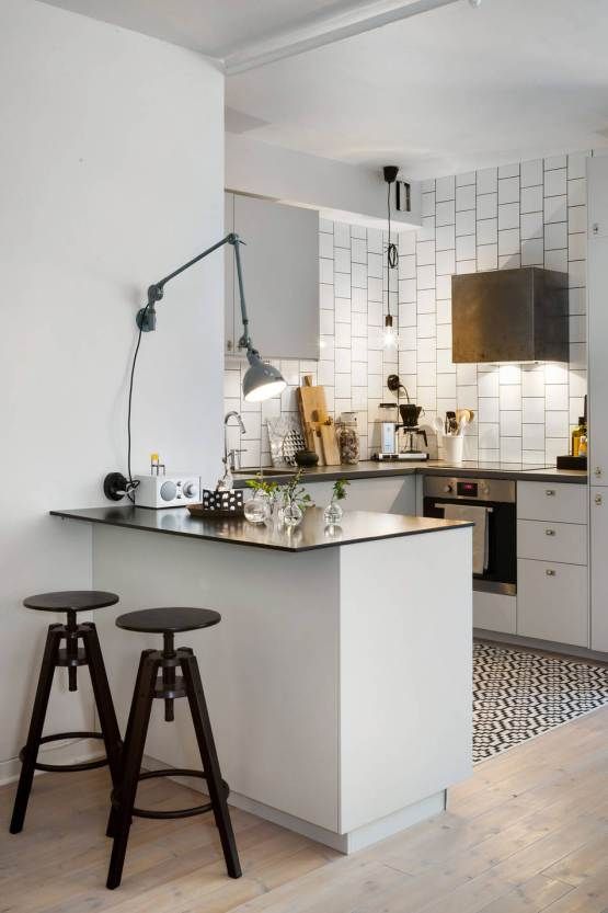 https://www.digsdigs.com/photos/2018/08/20-a-small-white-kitchen-island-with-a-black-countertop-and-black-industrial-stools-for-having-breakfasts.jpg