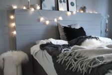 21 a grey bedroom spruced up with lights and a monochromatic gallery wall, black bedding