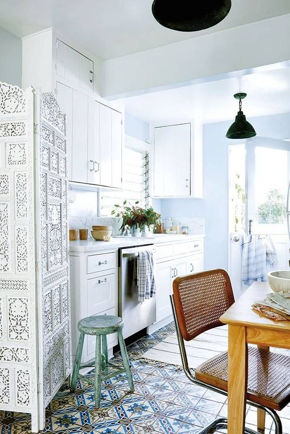 a mosaic tile floor, a wooden chair and a Moroccan style white space divider for a boho chic look