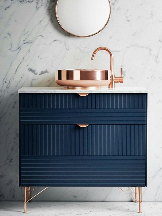 a navy geometric vanity with copper touches is a bold idea for a modern or art deco bathroom