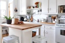 22 a small white kitchen island with storage shelves and a meal zone with stools