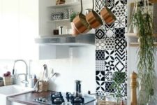 22 a vertical mosaic tile feature, a tree branch pot holder and cascading greenery in a hanging planter for a boho feel