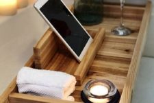 22 a wooden bath tray with comfy handles and a large gadget or book holder is a very functional piece