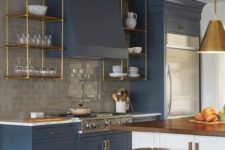 22 navy vintage-inspired cabinets are enlivened with a white kitchen island with a wooden countertop for a wow look