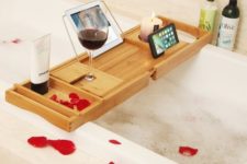 24 a modern bathroom caddy with a wine glass holder, a candle holder and a gadget stand