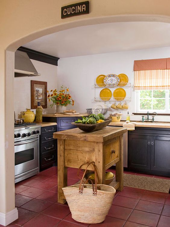 a vintage rustic kitchen with a massive wooden island with a drawer and open storage
