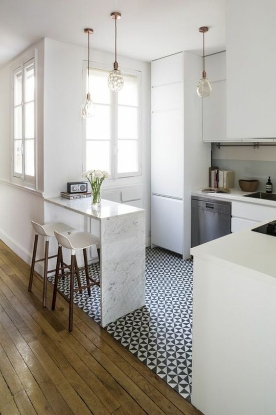 a waterfall kitchen island of stone doubles as a breakfast space