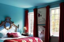 25 burgundy curtains, pillows and a bedspread contrast the blues and create a unique space