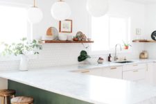 25 white cabinets and a green kitchen island are united with the same countertops for a continuous look