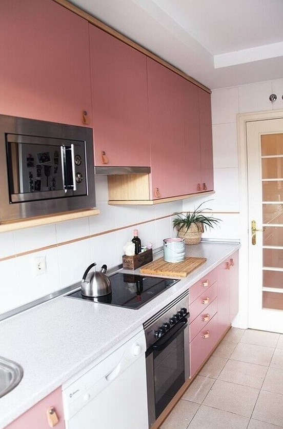 a bright pink modern kitchen with leather handles, neutral countertops and a backsplash looks chic and cool