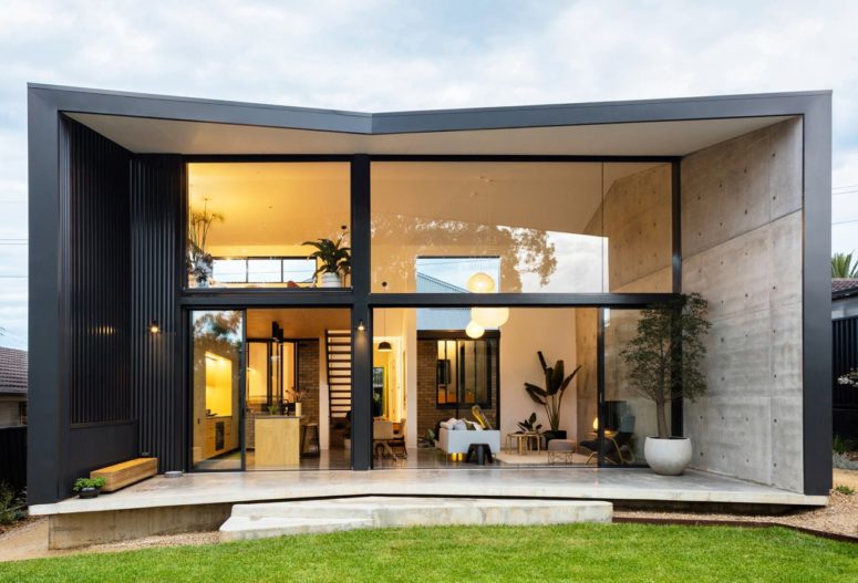 This cool pavilion like home addition is an amazing contemporary space with a glazed wall that opens it up to the backyard