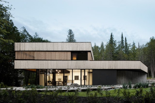 This minimalist home with bold architecture and natural materials used was built for a couple on a lake This minimalist home with bold architecture and natural materials used was built for a couple on a lake
