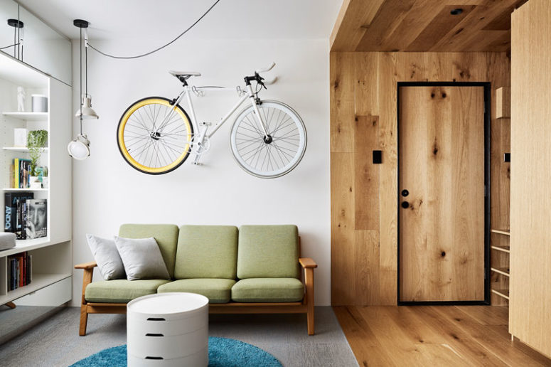 This small apartment features a lot of hidden storage elements and space saving solutions