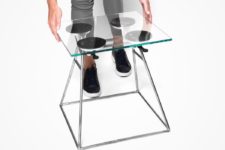 02 The stool features a metal base, some suction cups and a glass top or seat