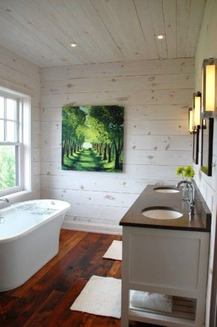 a rustic bathroom done with whitewashed pine walls with knots looks very inviting and relaxed