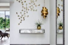 02 a silver floating console table, a sculptural brass lamp and a botanical artwork for a wow effect