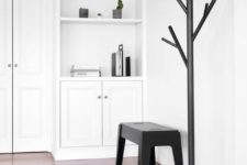 03 a black metal stem coat stand is right what you need for a minimalist space, spruce it up with its original design
