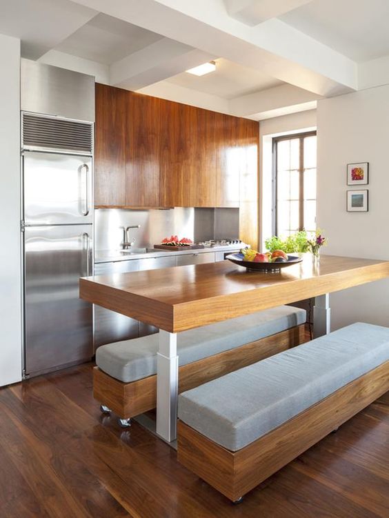 a dining space built in right into the kitchen, with a large table and a couple of upholstered benches