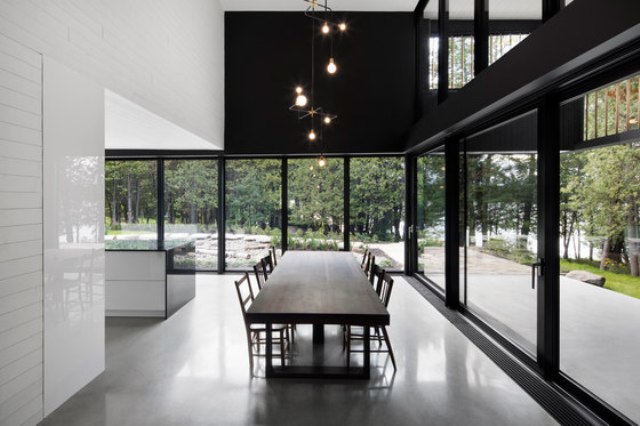 The dining space is done with a large table and chairs and cool hanging lights over the table, the views are amazing The dining space is done with a large table and chairs and cool hanging lights over the table, the views are amazing
