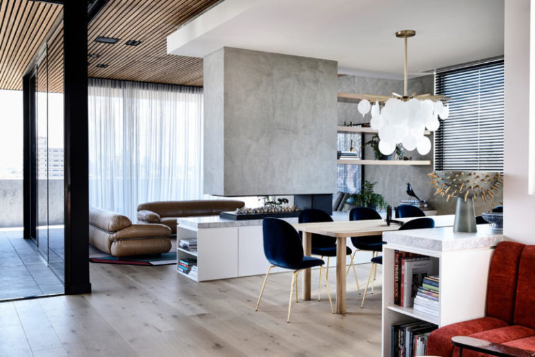 The living room and dining space are separated with a fireplace and shelves