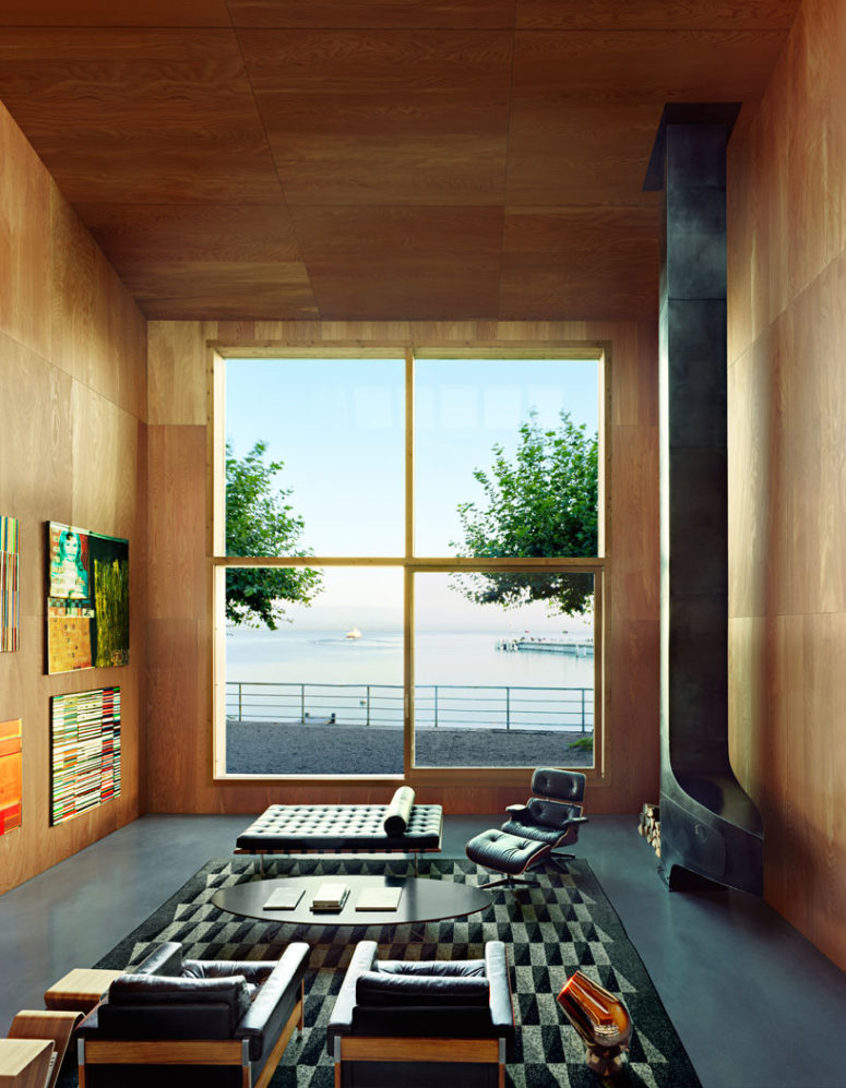 The living room is done with a giant window that lets enjoy the views and fills the space with light The living room is done with a giant window that lets enjoy the views and fills the space with light