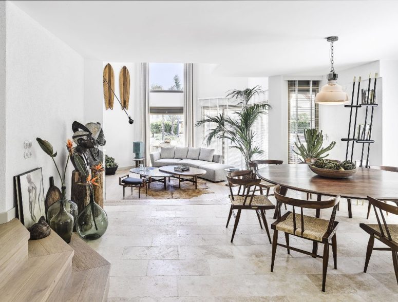 The living room is done with double height windows that flood the space with natural light and features comfy furniture The living room is done with double height windows that flood the space with natural light and features comfy furniture