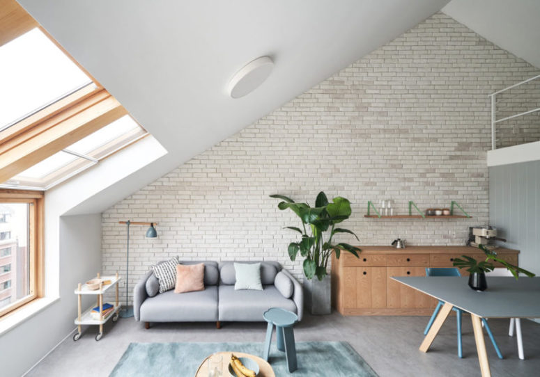 The living space is done with a comfy sofa, a side table, a potted plant and a trolley, which can be moved anywhere The living space is done with a comfy sofa, a side table, a potted plant and a trolley, which can be moved anywhere
