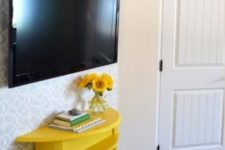 a comfy TV console of a half cut table painted bold yellow will provide some storage without taking much space