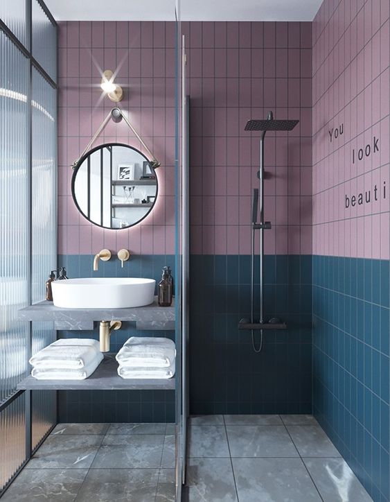 dusty pink and teal are an elegant combo for a bathroom and they look good with grey and gold fixtures that are present