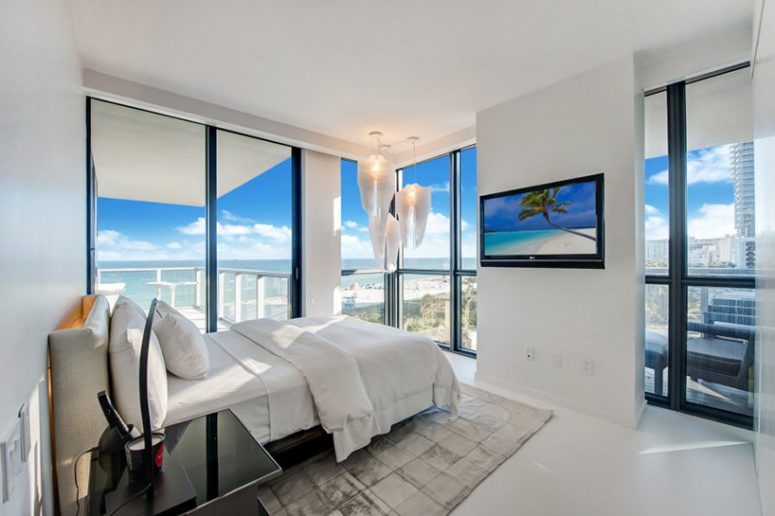 One of the bedrooms is done in white, with lots of glazing, pendant lamps that remind of jelly fish and minimalist furniture One of the bedrooms is done in white, with lots of glazing, pendant lamps that remind of jelly fish and minimalist furniture
