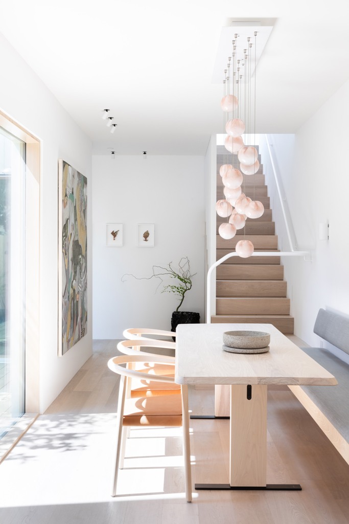 The dining space is done with an upholstered bench, a table and chairs plus pendant lamps over the table to accent it The dining space is done with an upholstered bench, a table and chairs plus pendant lamps over the table to accent it