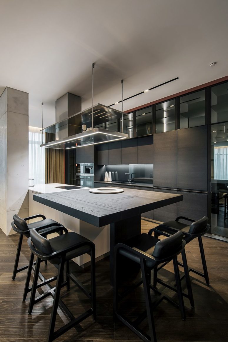 The dining space is done with this tabletop attached to the kitchen island and there are large stools The dining space is done with this tabletop attached to the kitchen island and there are large stools