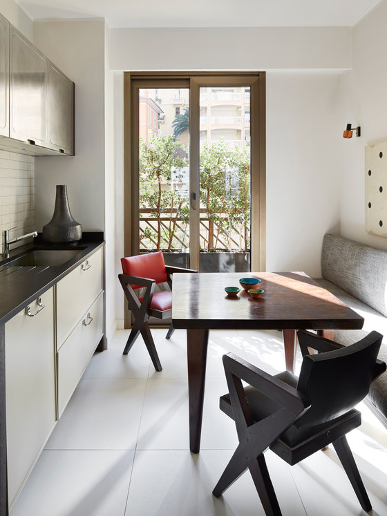 The kitchen is rather small and its main accent feture is sculptural chairs and a table plus an upholstered bench The kitchen is rather small and its main accent feture is sculptural chairs and a table plus an upholstered bench