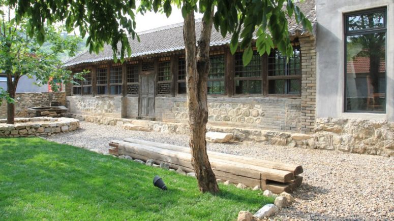 The outdoor spaces are styled with gravel and lawns, there's stone cladding and benches made of logs The outdoor spaces are styled with gravel and lawns, there's stone cladding and benches made of logs