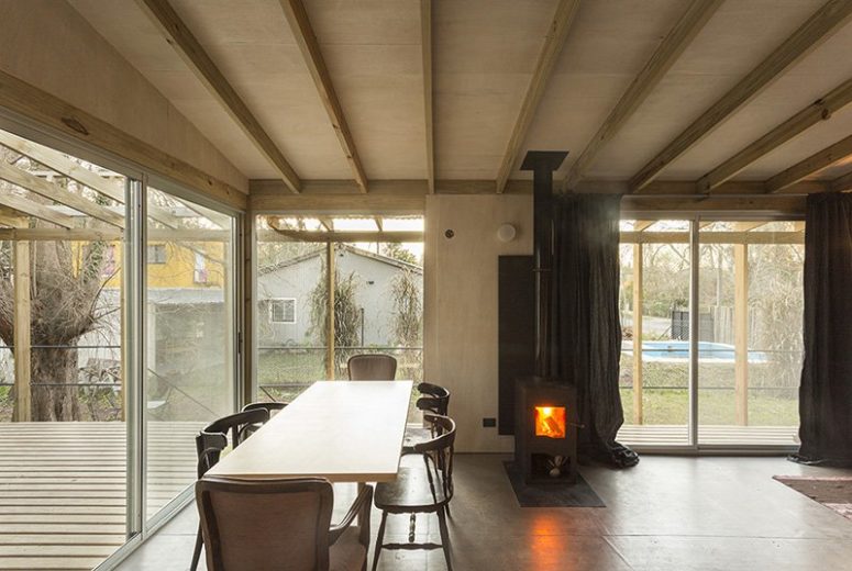 The spaces are done with wooden beams on the ceiling and there are a lot of windows and sliding doors that bring natural light inside The spaces are done with wooden beams on the ceiling and there are a lot of windows and sliding doors that bring natural light inside