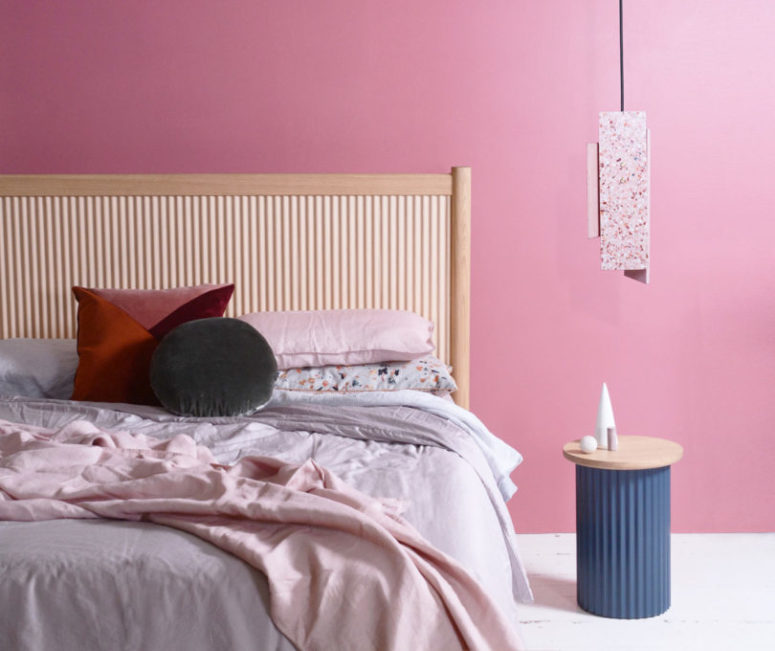 There are beds, side tables, a coffee table, a bench, a stool, and a buffet finished with wood or stone