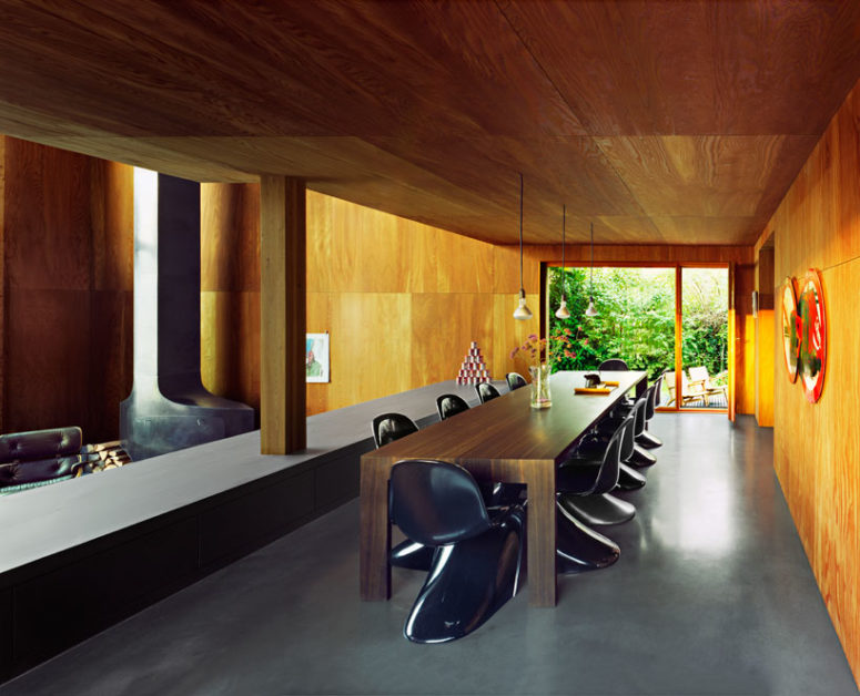 wooden space divider with very cozy look There's a space divider to divide the living room and the dining space with stylish curved chairs and a plywood table