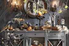 05 a moody Halloween console with giant spiders, fake pumpkins, skulls and candles