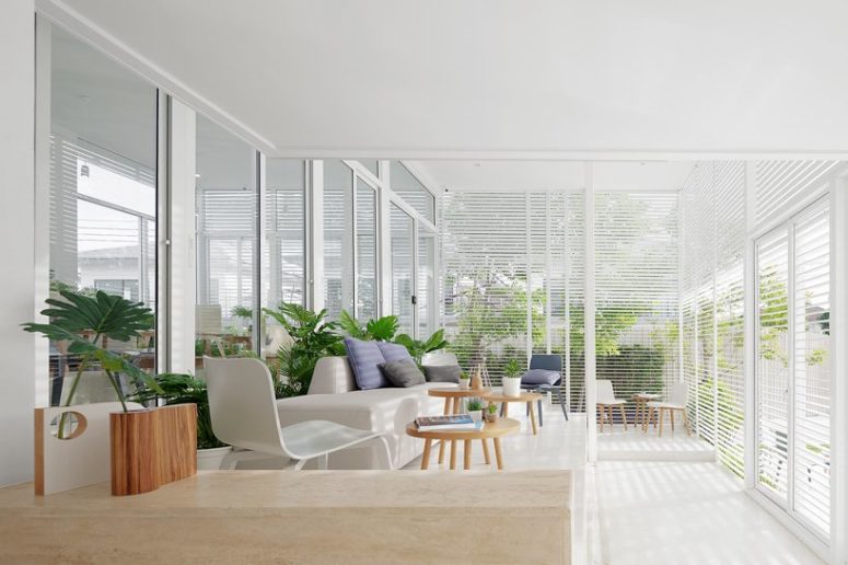 coastal inspired sunroom design in white tones It's a comfy sunroom with aluminum screens that provide enough sunlight filtering