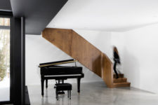 The living room incorporates a large piano as the owners are music lovers