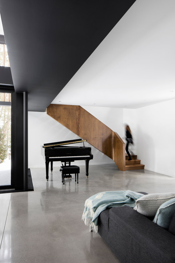 The living room incorporates a large piano as the owners are music lovers
