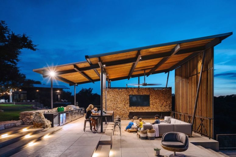 There's a pavilion that sits by the pool features a kitchen, a dining space and a sunken living room