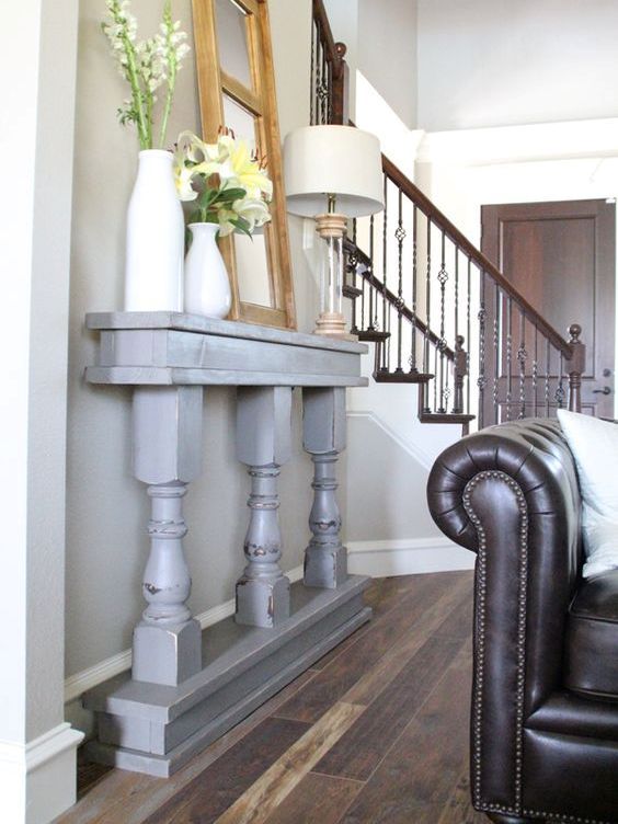 a grey vintage console of a table cut in halves is a great fit for this vintage space