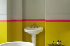 06 a sunny yellow and light green bathroom with a bold pink stripe looks really bold and unusual